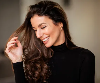 Brunette woman smiling and looking down
